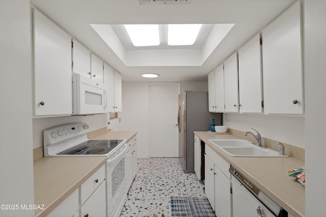 5701 E Glenn St Unit 57, Tucson, AZ 85712 - kitchen with white appliances, white cabinets, a sink, and light countertops