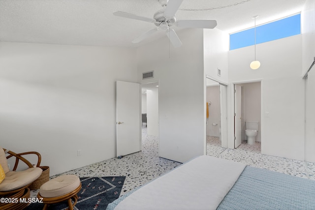 5701 E Glenn St Unit 57, Tucson, AZ 85712 - bedroom featuring a ceiling fan, visible vents, speckled floor, high vaulted ceiling, and ensuite bathroom