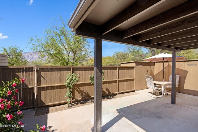 5701 E Glenn St Unit 57, Tucson, AZ 85712 - view of patio / terrace featuring a fenced backyard and a mountain view