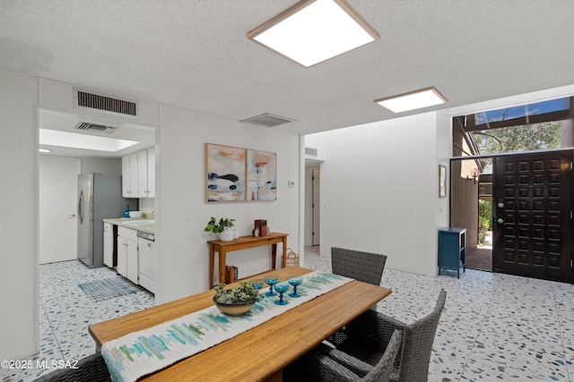 5701 E Glenn St Unit 57, Tucson, AZ 85712 - dining area featuring visible vents and a textured ceiling