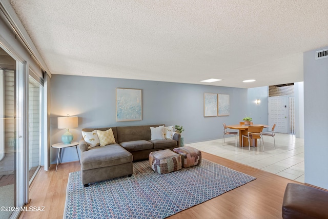 5701 E Glenn St Unit 61, Tucson, AZ 85712 - living area featuring a textured ceiling and wood finished floors