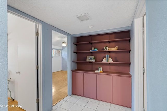 5701 E Glenn St Unit 61, Tucson, AZ 85712 - corridor featuring a textured ceiling and light tile patterned flooring