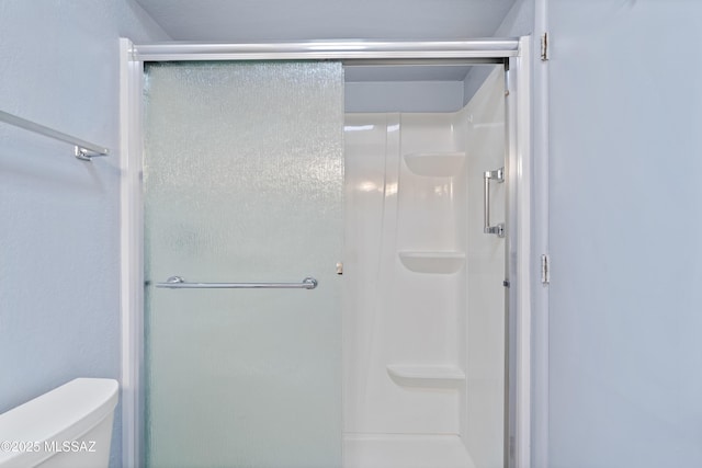 5701 E Glenn St Unit 61, Tucson, AZ 85712 - bathroom featuring a stall shower and toilet