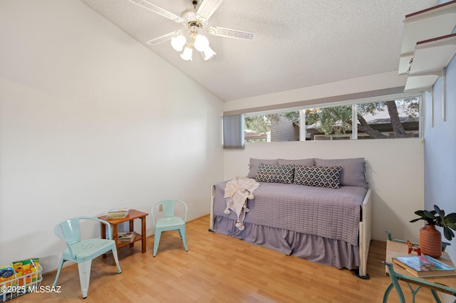 5701 E Glenn St Unit 61, Tucson, AZ 85712 - bedroom with a textured ceiling, wood finished floors, and lofted ceiling