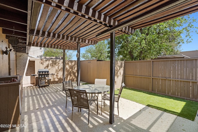 5701 E Glenn St Unit 61, Tucson, AZ 85712 - view of patio with a fenced backyard, grilling area, a pergola, and outdoor dining space