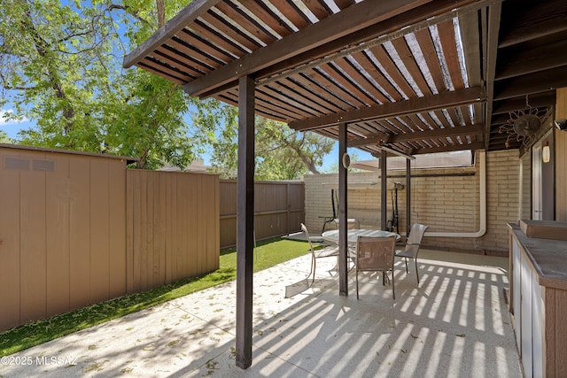 5701 E Glenn St Unit 61, Tucson, AZ 85712 - view of patio / terrace featuring a fenced backyard, a pergola, and outdoor dining space
