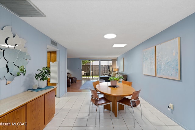 5701 E Glenn St Unit 61, Tucson, AZ 85712 - dining space with baseboards, visible vents, and light tile patterned floors