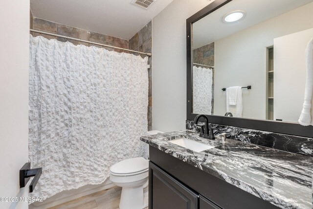 6624 N Galaxy Rd, Tucson, AZ 85741 - bathroom with wood finished floors, visible vents, toilet, vanity, and a shower with curtain