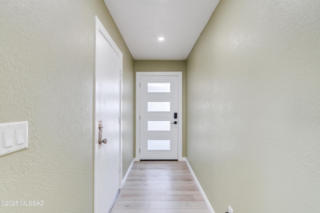 6624 N Galaxy Rd, Tucson, AZ 85741 - entryway with baseboards, a textured wall, and light wood finished floors