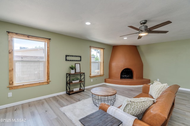 6624 N Galaxy Rd, Tucson, AZ 85741 - living area with recessed lighting, a ceiling fan, baseboards, a fireplace, and light wood-style flooring