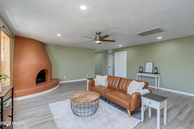 6624 N Galaxy Rd, Tucson, AZ 85741 - living room with recessed lighting, wood finished floors, visible vents, and baseboards