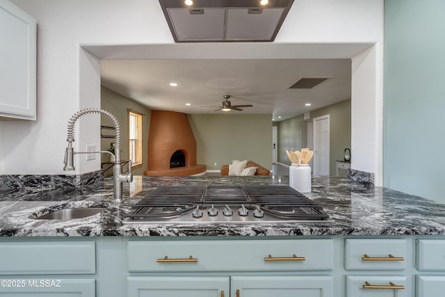 6624 N Galaxy Rd, Tucson, AZ 85741 - kitchen with visible vents, a sink, stainless steel gas cooktop, a peninsula, and open floor plan