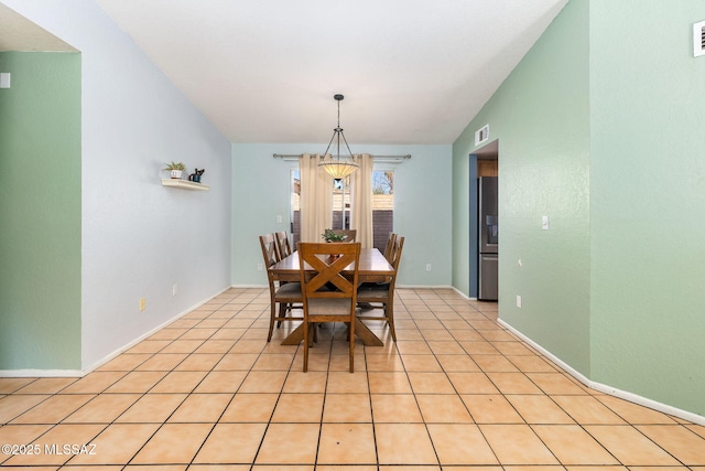 dining area with vaulted ceiling, visible vents, and light tile patterned floors