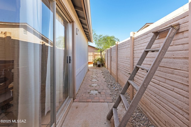 view of side of property featuring fence and a patio area
