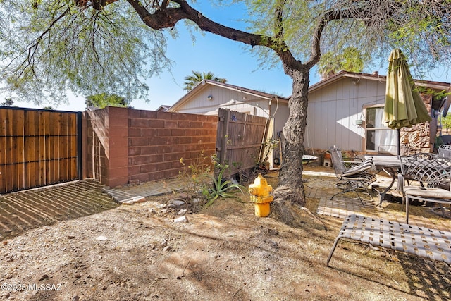 view of yard featuring a patio and fence