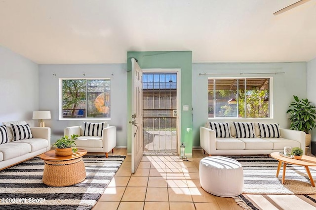 living area with a wealth of natural light and light tile patterned floors