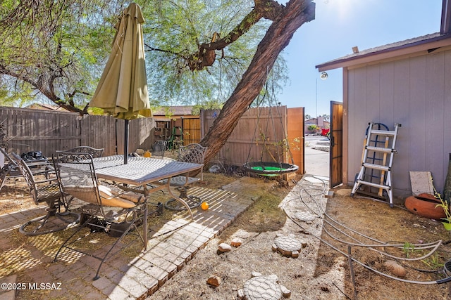 view of patio with outdoor dining space and a fenced backyard