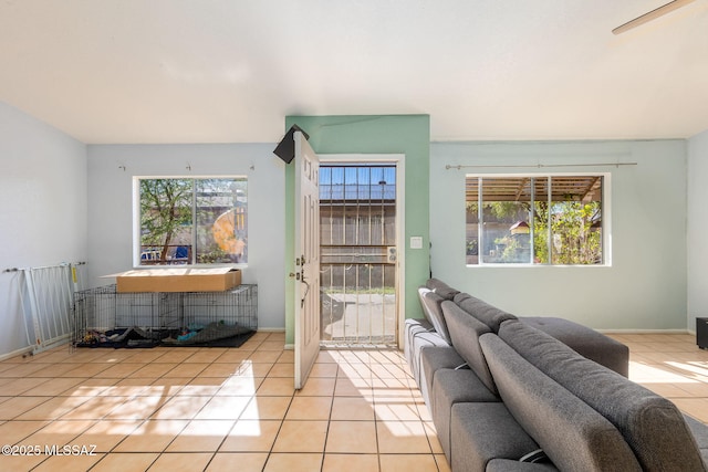doorway to outside with baseboards and light tile patterned floors