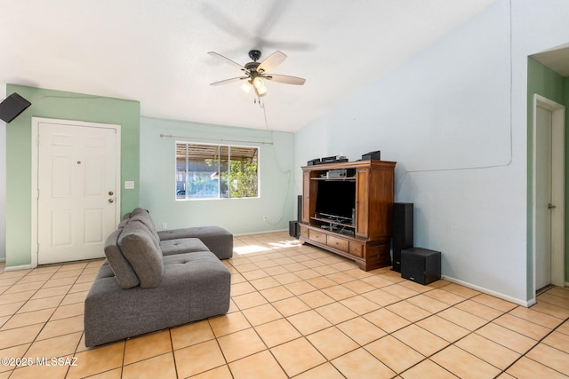 living area with baseboards, vaulted ceiling, a ceiling fan, and light tile patterned floors