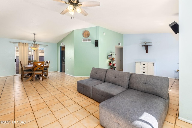living area featuring baseboards, visible vents, lofted ceiling, ceiling fan, and light tile patterned floors