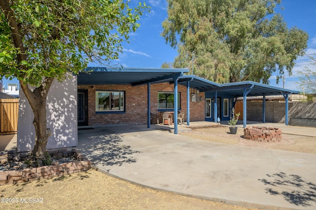 2245 N Northway Ave, Tucson, AZ 85716 - back of property with fence, driveway, an attached carport, and brick siding