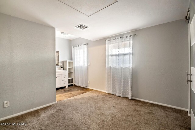 2245 N Northway Ave, Tucson, AZ 85716 - unfurnished bedroom featuring baseboards, a textured wall, visible vents, and carpet