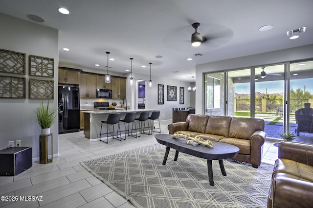 5854 W Indian Sunrise Dr, Tucson, AZ 85742 - living room featuring baseboards, a ceiling fan, recessed lighting, and visible vents