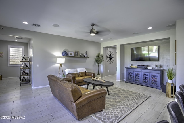 5854 W Indian Sunrise Dr, Tucson, AZ 85742 - living area featuring wood tiled floor, ceiling fan, baseboards, and visible vents