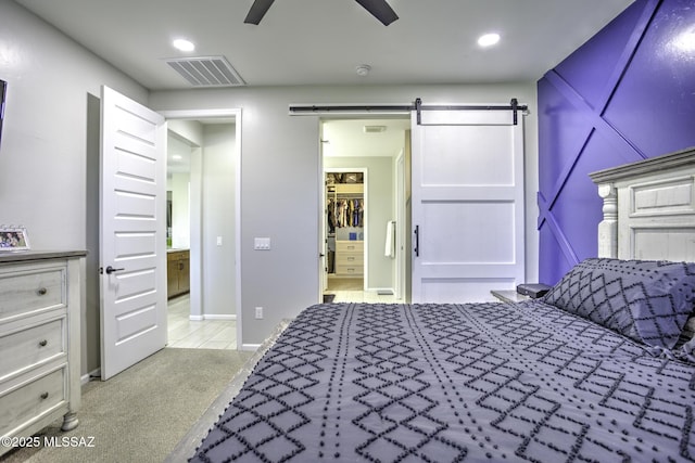 5854 W Indian Sunrise Dr, Tucson, AZ 85742 - bedroom featuring a ceiling fan, light colored carpet, visible vents, a barn door, and recessed lighting
