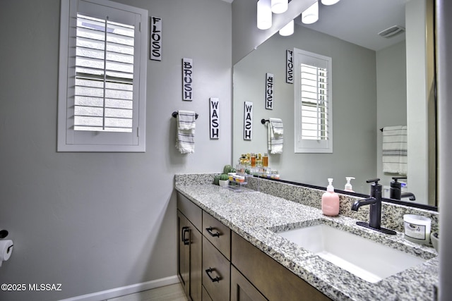 5854 W Indian Sunrise Dr, Tucson, AZ 85742 - bathroom featuring baseboards, visible vents, and vanity