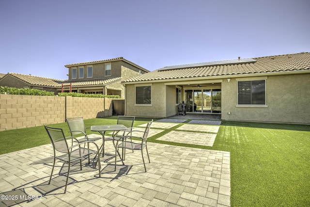 5854 W Indian Sunrise Dr, Tucson, AZ 85742 - rear view of property featuring a patio, fence, roof mounted solar panels, and stucco siding