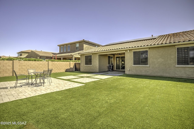 5854 W Indian Sunrise Dr, Tucson, AZ 85742 - back of house with fence, ceiling fan, a patio area, a tiled roof, and a yard