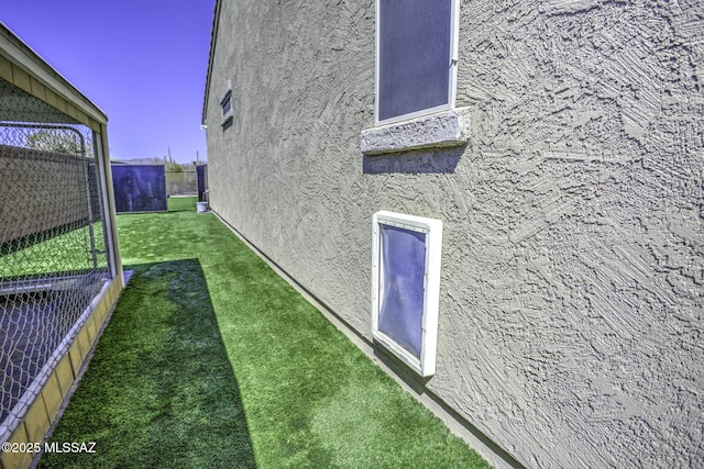5854 W Indian Sunrise Dr, Tucson, AZ 85742 - view of side of home featuring a lawn, fence, and stucco siding