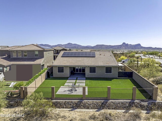5854 W Indian Sunrise Dr, Tucson, AZ 85742 - back of house with a patio, solar panels, a fenced backyard, and stucco siding