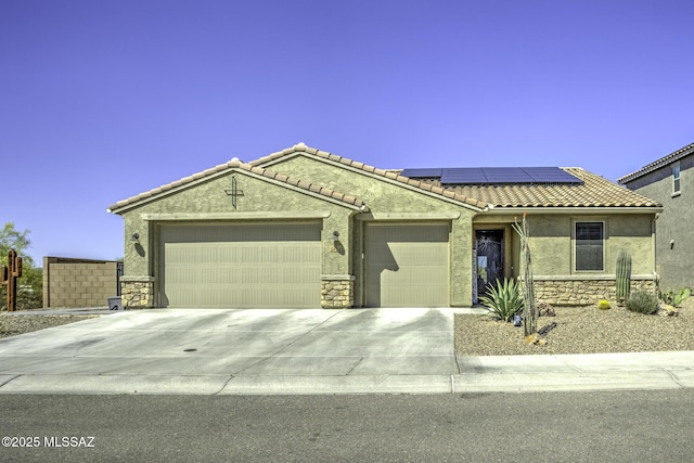 5854 W Indian Sunrise Dr, Tucson, AZ 85742 - single story home with concrete driveway, an attached garage, roof mounted solar panels, and stone siding