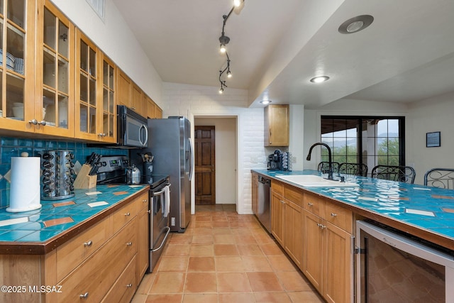 5122 W Camino De La Amapola, Tucson, AZ 85745 - kitchen with appliances with stainless steel finishes, wine cooler, a sink, tile countertops, and glass insert cabinets