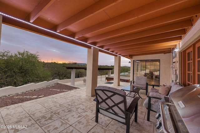 5122 W Camino De La Amapola, Tucson, AZ 85745 - patio terrace at dusk featuring a patio, an outdoor hangout area, and grilling area