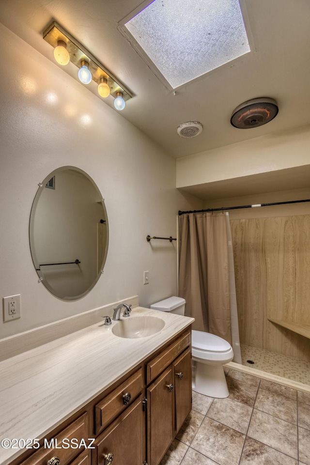 bathroom with toilet, a shower with curtain, tile patterned floors, and vanity