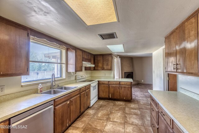 kitchen featuring a sink, white electric range, visible vents, light countertops, and dishwasher