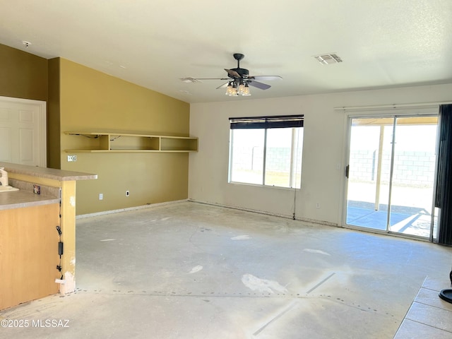 10211 E Hummingbird Meadow Way, Tucson, AZ 85747 - unfurnished living room featuring ceiling fan, lofted ceiling, visible vents, and concrete floors