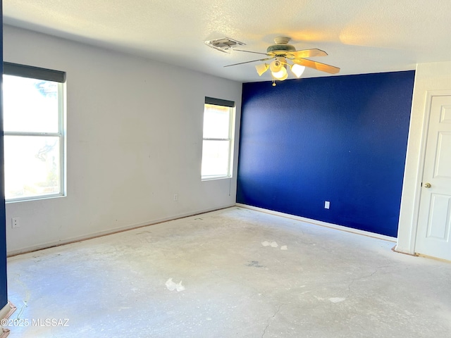 10211 E Hummingbird Meadow Way, Tucson, AZ 85747 - unfurnished room featuring unfinished concrete floors, visible vents, baseboards, and ceiling fan