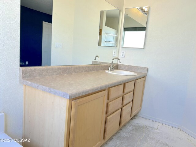 10211 E Hummingbird Meadow Way, Tucson, AZ 85747 - bathroom featuring baseboards, marble finish floor, and vanity