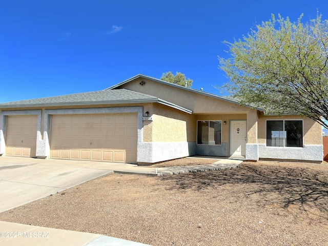 10211 E Hummingbird Meadow Way, Tucson, AZ 85747 - view of front of property featuring stucco siding, concrete driveway, and a garage