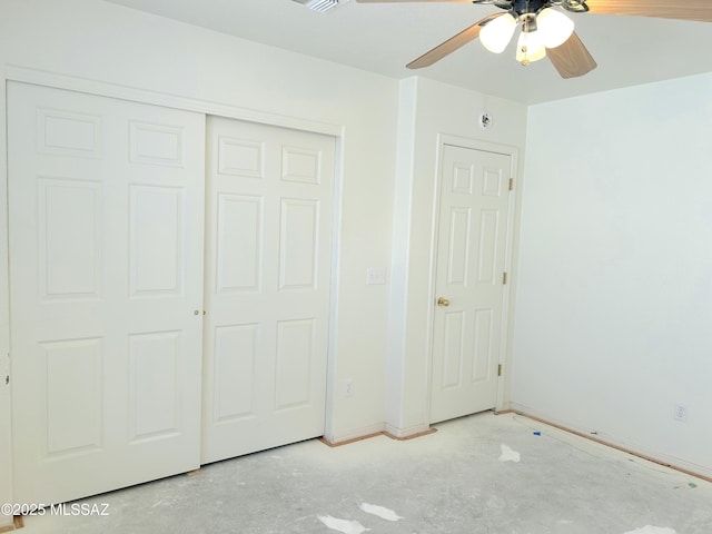 10211 E Hummingbird Meadow Way, Tucson, AZ 85747 - unfurnished bedroom with unfinished concrete floors, a closet, baseboards, and ceiling fan