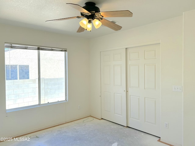 10211 E Hummingbird Meadow Way, Tucson, AZ 85747 - unfurnished bedroom with concrete flooring, a closet, a ceiling fan, and multiple windows