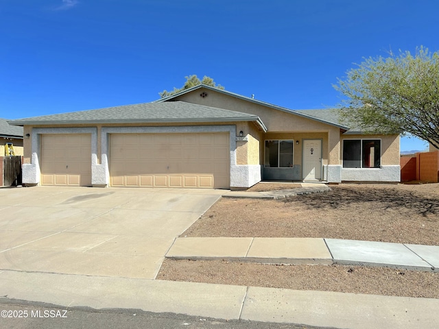 10211 E Hummingbird Meadow Way, Tucson, AZ 85747 - ranch-style house featuring an attached garage, driveway, roof with shingles, and stucco siding