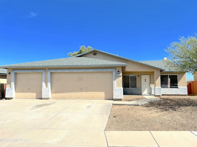 10211 E Hummingbird Meadow Way, Tucson, AZ 85747 - single story home with concrete driveway, an attached garage, roof with shingles, and stucco siding