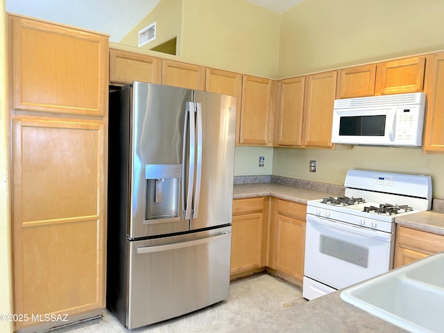 10211 E Hummingbird Meadow Way, Tucson, AZ 85747 - kitchen with light countertops, visible vents, light brown cabinets, a sink, and white appliances