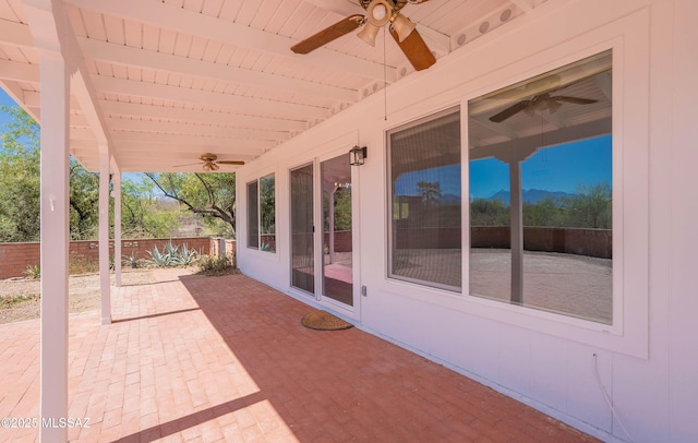view of patio featuring fence and ceiling fan