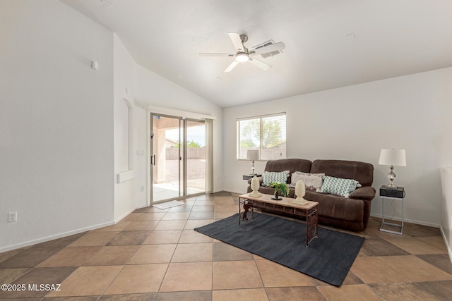 living area featuring baseboards, ceiling fan, and vaulted ceiling